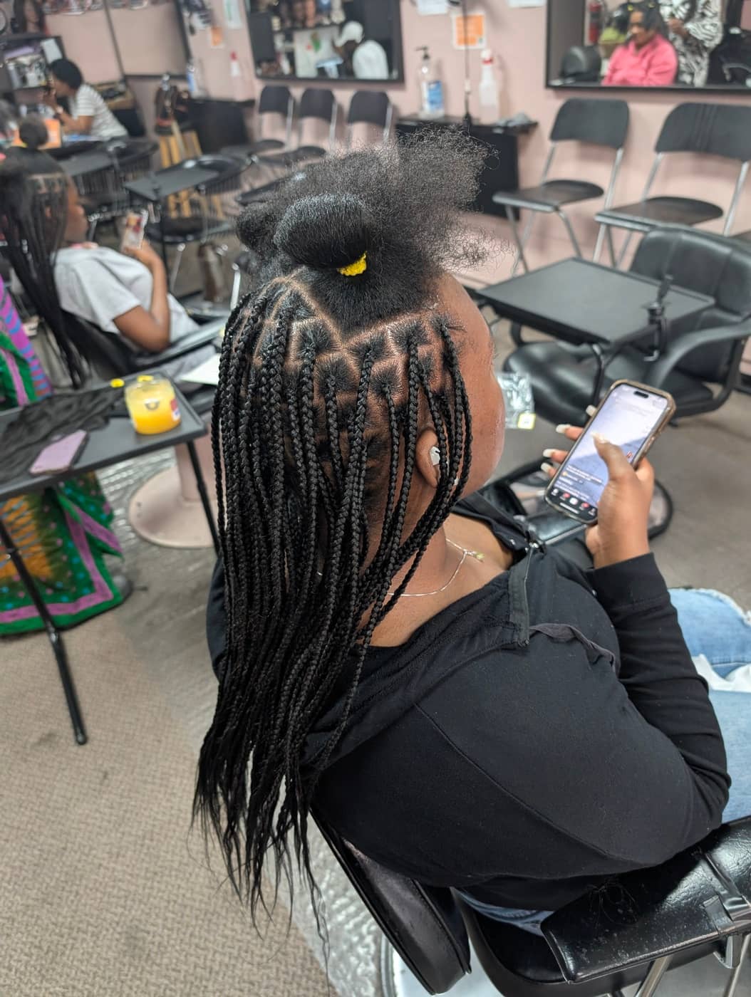 Knotless braids in progress showing feed-in technique