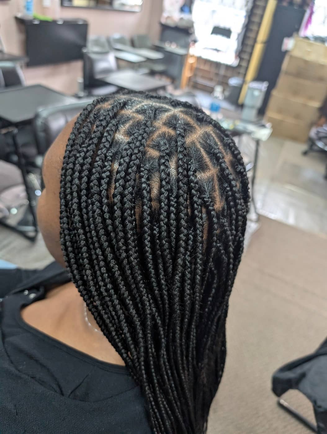 Close-up of clean box parting on finished knotless braids